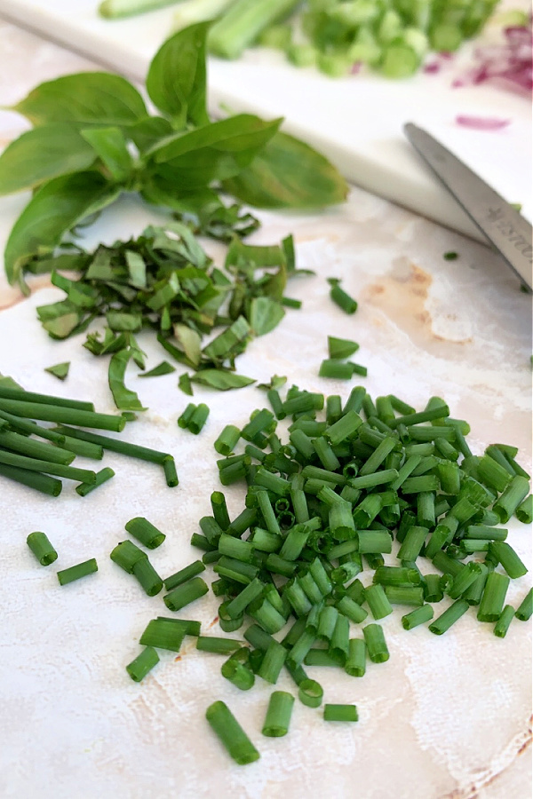 chopped chives and basil for creamy chicken stuffed tomatoes