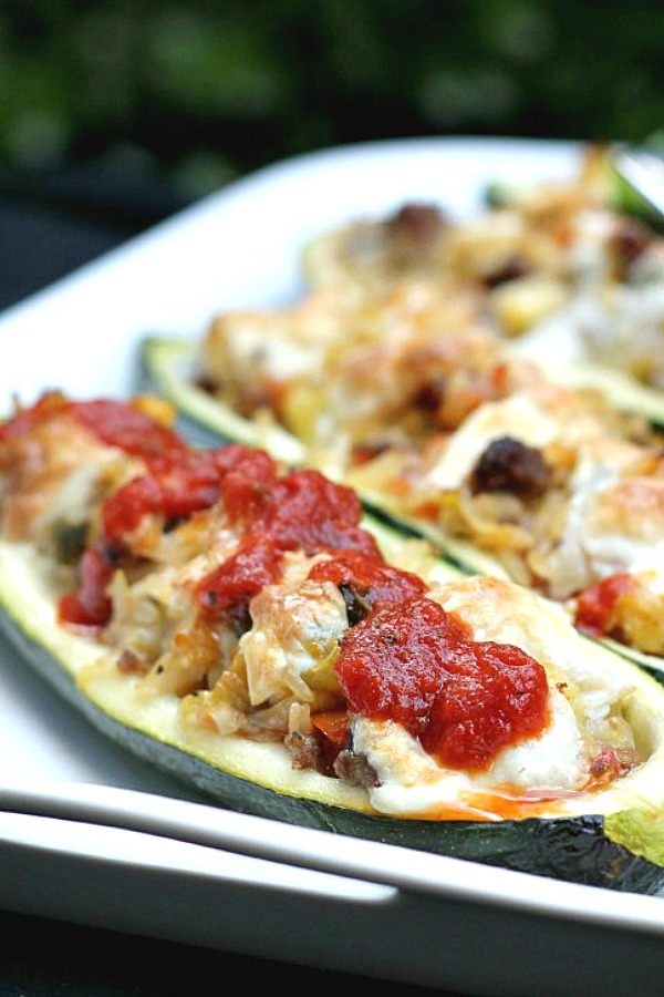 Easy recipe for a great summer meal. Garden fresh zucchini boats are stuffed with sausage, rice, tomatoes, Parmesan and mozzarella cheese for a tasty summer entree.