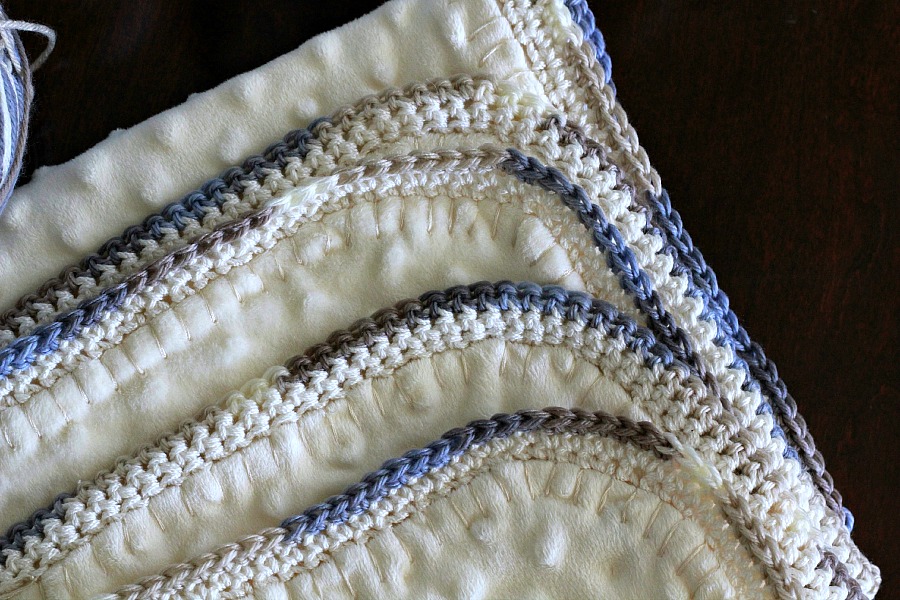 Crochet edge baby blanket with a sweet border around a fleece fabric creating a cozy, snuggly lovey. Perfect baby shower gift or as a sofa throw.