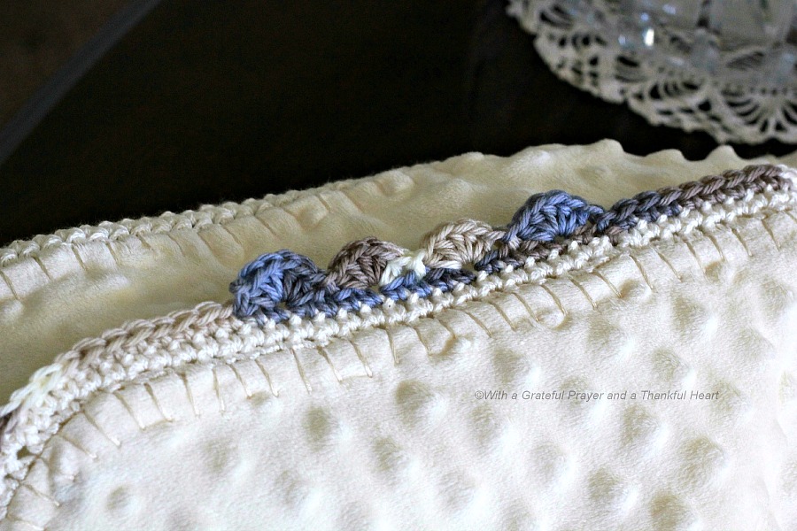 Crochet edge baby blanket with a sweet border around a fleece fabric creating a cozy, snuggly lovey. Perfect baby shower gift or as a sofa throw.