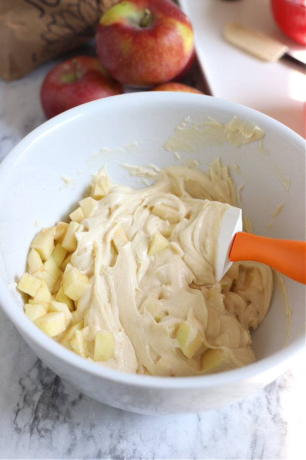 adding the apples to the batter for apple coffee cake