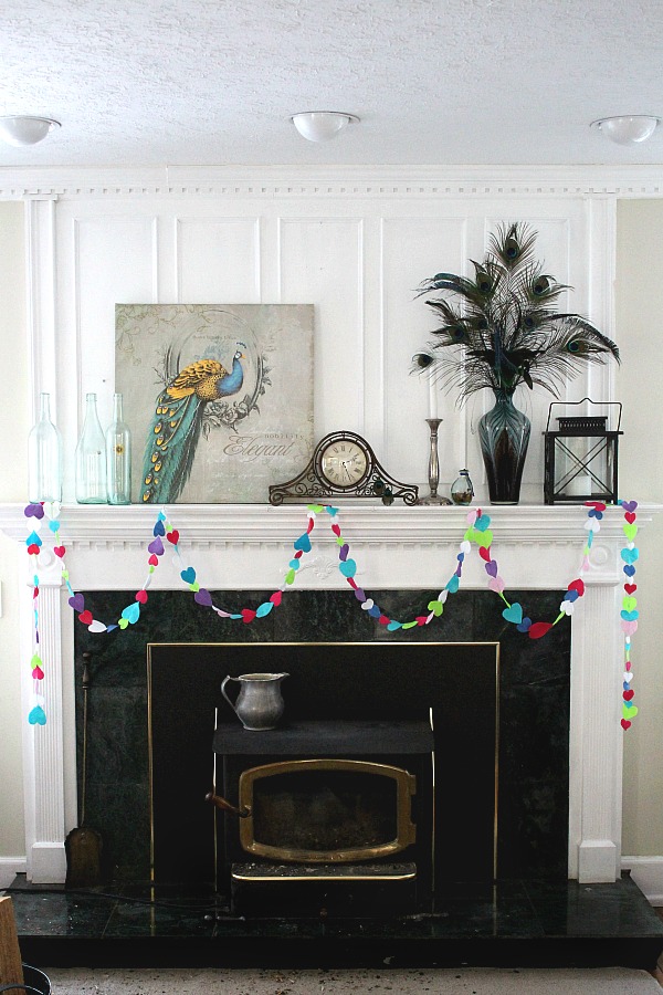 Easy Valentine's Day garland made by sewing felt hearts together. Hang hearts overflowing garland on the mantle, a window or wherever happy hearts are wanted.