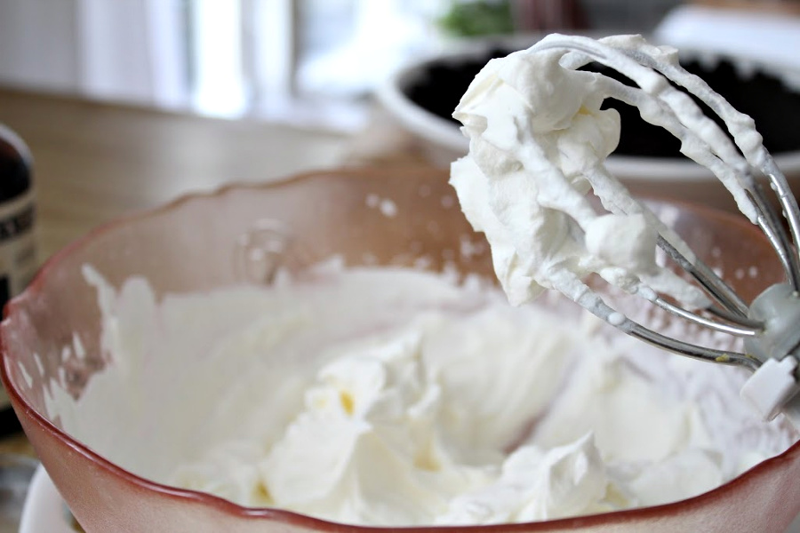 Easy recipe for frozen minty mousse pie with a layers of ice cream, chocolate mousse and whipped cream in a cookie crust is just right for St Patrick's Day