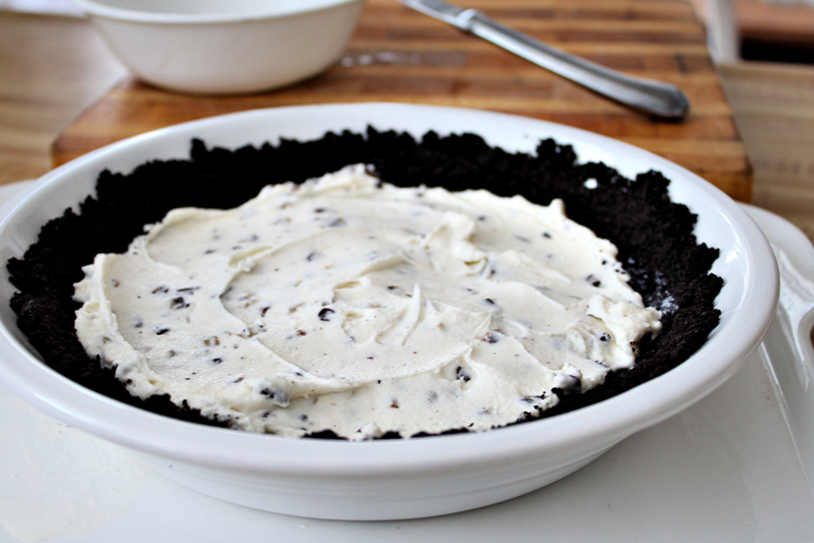 Easy recipe for frozen minty mousse pie with a layers of ice cream, chocolate mousse and whipped cream in a cookie crust is just right for St Patrick's Day