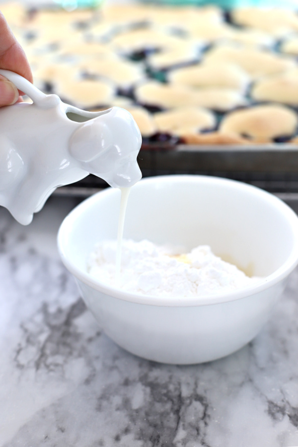 Making the frosting glaze for cherry blueberry fruit bars.