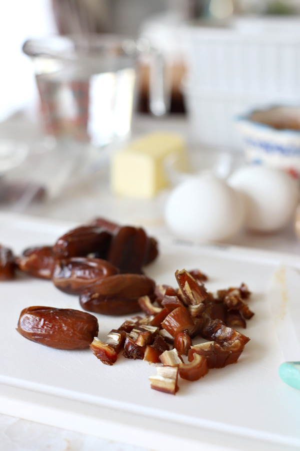 Dropping dried figs for making fig & date nut quick bread recipe.