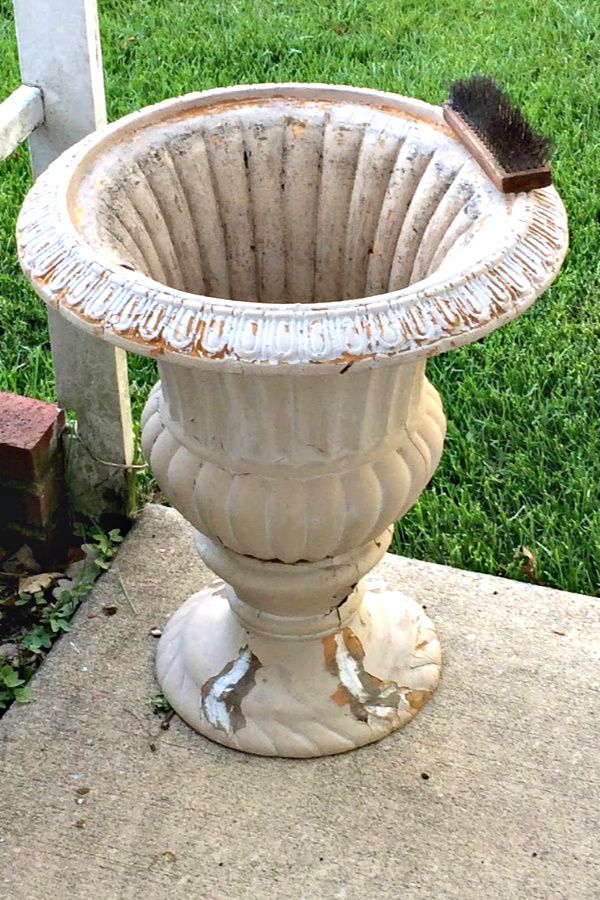 A garage sale urn was a DIY project. A little work and a new coat of paint resulted in a beautiful, farmhouse style porch planter for spring garden flowers with lots of curb appeal. Shade loving annuals flowers and coleus do exceptionally well.