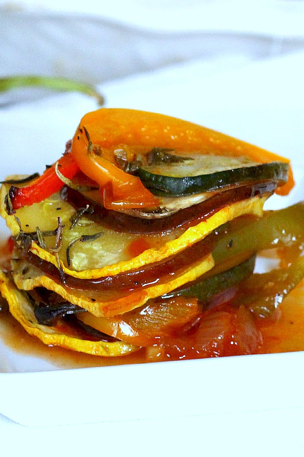 Kid-friendly ratatouille is a healthy combo of summer veggies. Easy recipe of sliced eggplant, zucchini, bell pepper and fresh herbs arranged over tomato sauce and baked until tender.