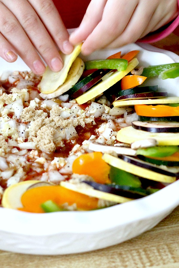 Kid-friendly ratatouille is a healthy combo of summer veggies. Easy recipe of sliced eggplant, zucchini, bell pepper and fresh herbs arranged over tomato sauce and baked until tender.