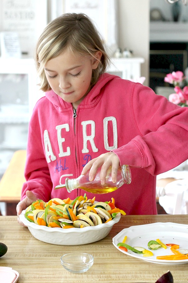 Kid-friendly ratatouille is a healthy combo of summer veggies. Easy recipe of sliced eggplant, zucchini, bell pepper and fresh herbs arranged over tomato sauce and baked until tender.