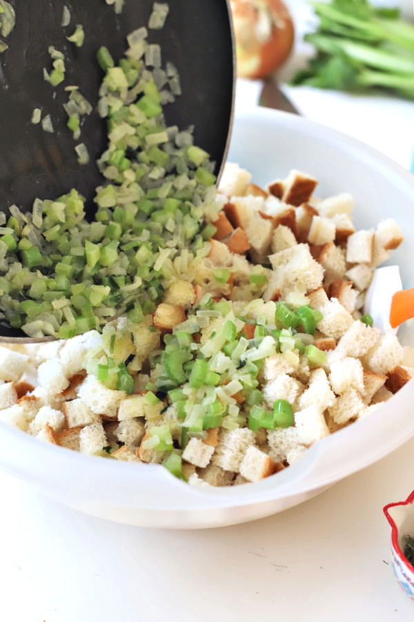 adding veggies to bread cubes