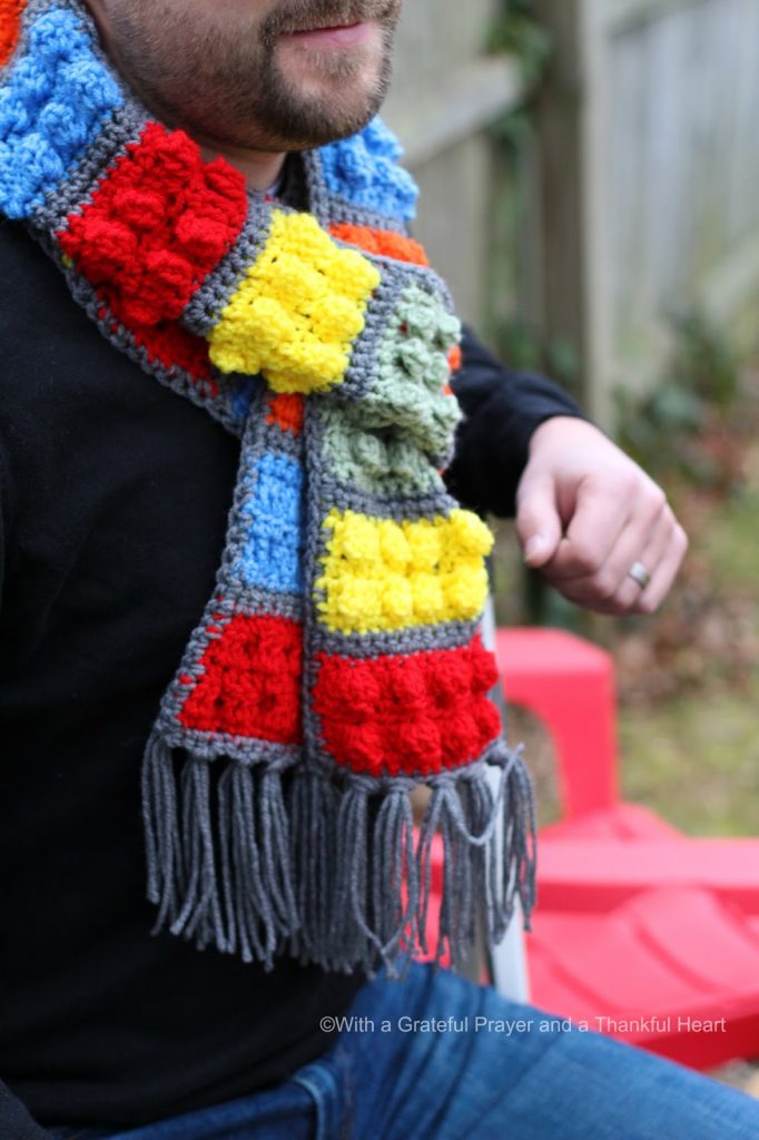 Easy pattern for a Crochet Lego Blocks Scarf for the hipster or kid on your gift-giving list. Colorful popcorn stitch creates Lego looking blocks.