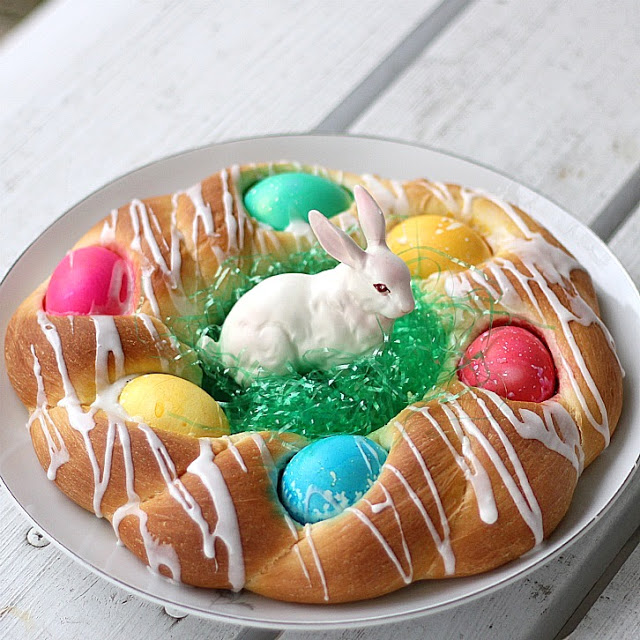 A beautiful Easter egg braided yeast bread tastes delicious and is so pretty with dyed eggs tucked into the braided ring then drizzled with a light glaze. Easy recipe using a bread machine to make the dough.