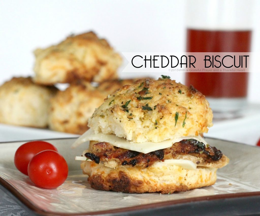 Easy recipe for homemade buttermilk cheddar cheese biscuits brushed with herb butter. Drop scoops of dough into pan and bake. No kneading or cutting involved.