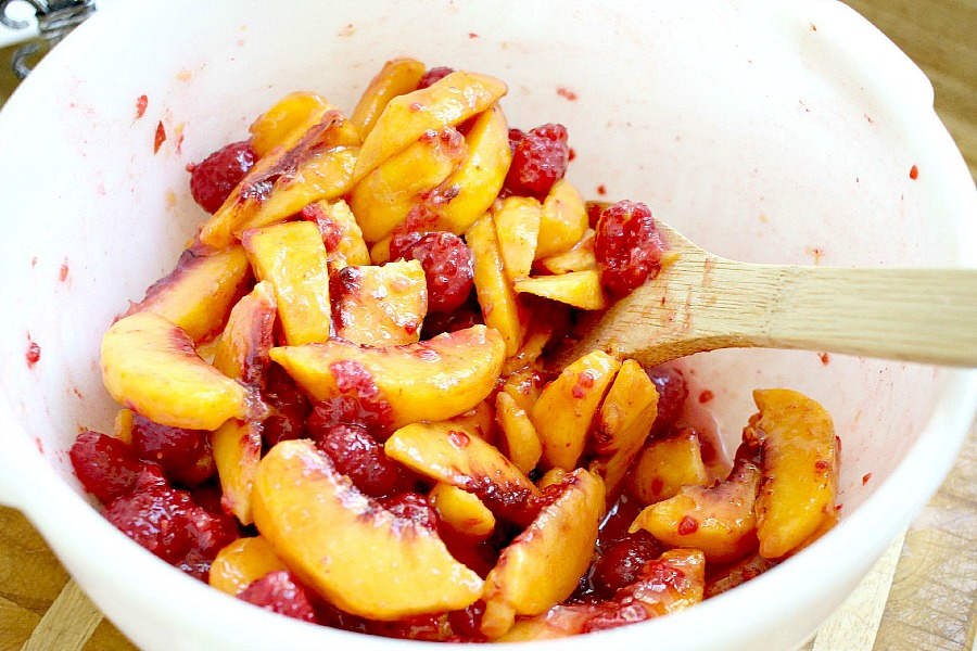 Make an easy Peach & Raspberry Crisp using fresh summer peaches and plump raspberries with a lovely crumb topping. Serve with a scoop of vanilla ice cream.