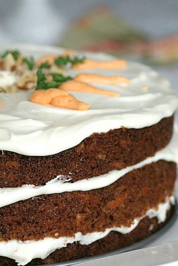 Classic three-layer carrot cake with cream cheese frosting is incredibly moist and delicious! Flecks of carrot, nuts and lightly spiced with cinnamon.