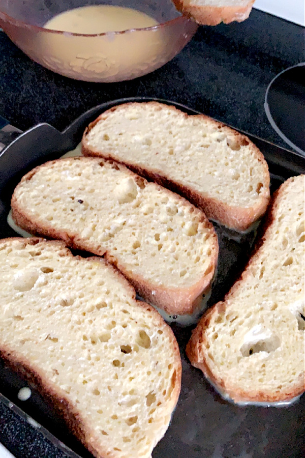 frying egg dipped bread for French toast breakfast