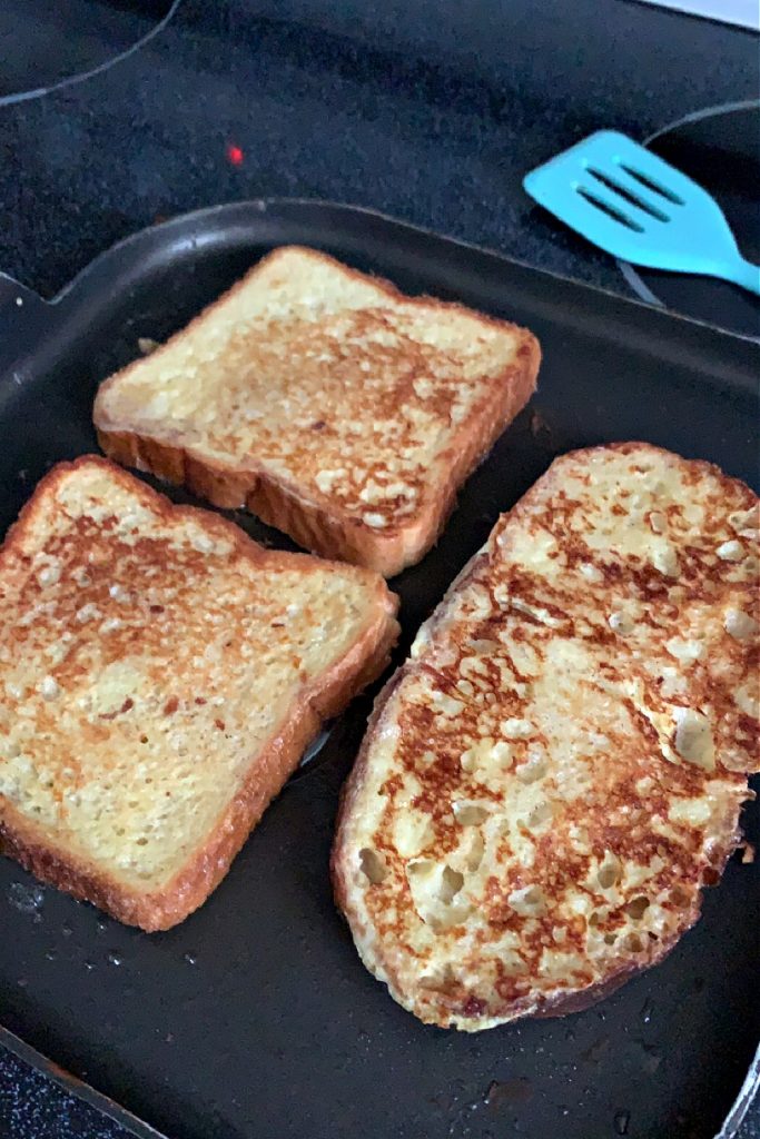 frying egg dipped bread for French toast breakfast