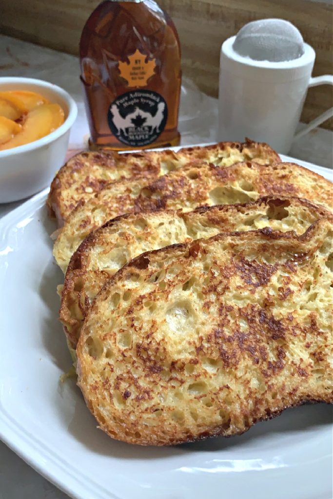 frying egg dipped bread for French toast breakfast