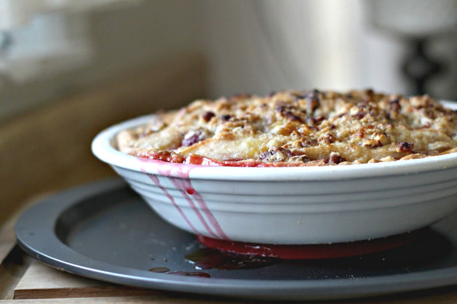 Easy recipe for cranberry apple pie with pecan streusel is an exciting combination of sweet and tart with a crunchy topping that's especially delicious served with a scoop of vanilla ice cream!