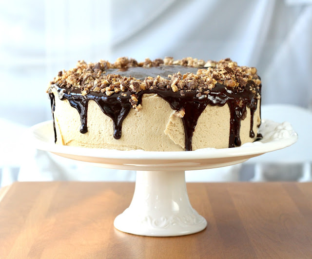 Birthday time cake. Dark, chocolaty cake with peanut butter frosting, ganache drizzled on top and down the sides then sprinkled with chopped snickers bars.