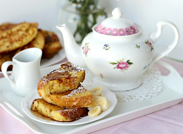 Thick slices of French Toast dusted with confectioners' sugar and served with maple syrup and fruit. It is like eating dessert for breakfast!