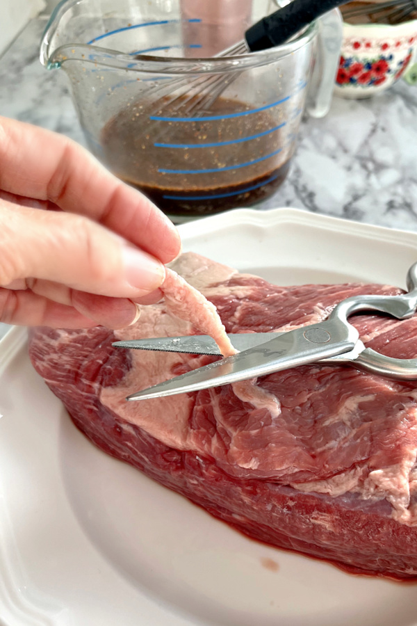 Trimming fat from beef brisket 