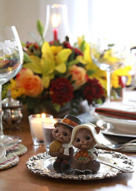 Flowers add a festive touch to your Thanksgiving table. Lovely autumn colors with a hurricane globe & candles creates an elegant tablescape. 