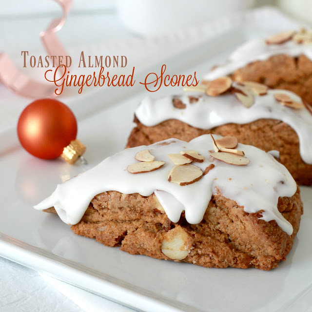 Toasted almond gingerbread scones are frosted and topped with a sprinkling of almonds. Delicious and festive holiday flavor for breakfast or coffee break.