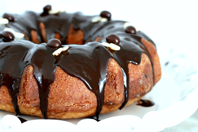 How to make an easy Coffee Marbled Bundt Cake with Dark Chocolate Ganache. Great birthday or any occasion dessert. Swirls of yellow cake and coffee flavored cake with a decadent dark chocolate ganache drizzled on top.