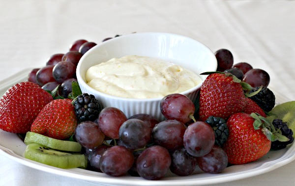 Super easy recipe for a delicious orange fruit dip made with cream cheese, orange zest, orange juice, cream and confectioners' sugar. It is the best!