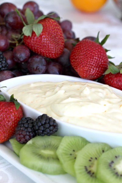 Super easy recipe for a delicious orange fruit dip made with cream cheese, orange zest, orange juice, cream and confectioners' sugar. It is the best!