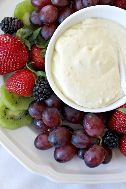 Super easy recipe for a delicious orange fruit dip made with cream cheese, orange zest, orange juice, cream and confectioners' sugar. It is the best!