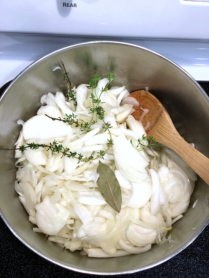 Easy recipe for French Onion soup in a rich beef broth with sweet caramelized onions and topped with toasted baguette and melty cheese. 