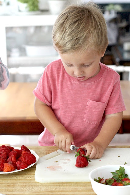 Strawberry Pie topped with whipped cream. Made this pie with two preschoolers for a fun and tasty baking-with-kids dessert.