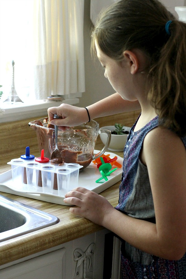 Enjoy an easy summertime recipe for homemade frozen chocolate peanut butter pudding pops for kids and adults alike.