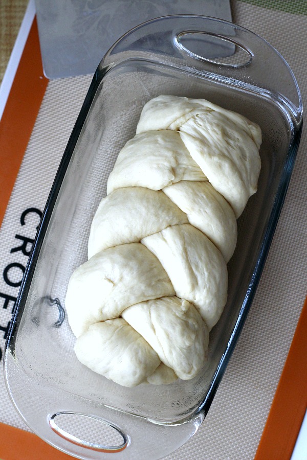 Bake a festive loaf of rich holiday brioche from easy recipe using a bread machine. Frosted with a white glaze and colorful sprinkles. Great food gift idea.