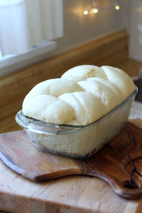 Bake a festive loaf of rich holiday brioche from easy recipe using a bread machine. Frosted with a white glaze and colorful sprinkles. Great food gift idea.