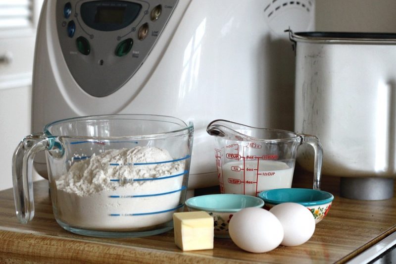 Bake a festive loaf of rich holiday brioche from easy recipe using a bread machine. Frosted with a white glaze and colorful sprinkles. Great food gift idea.