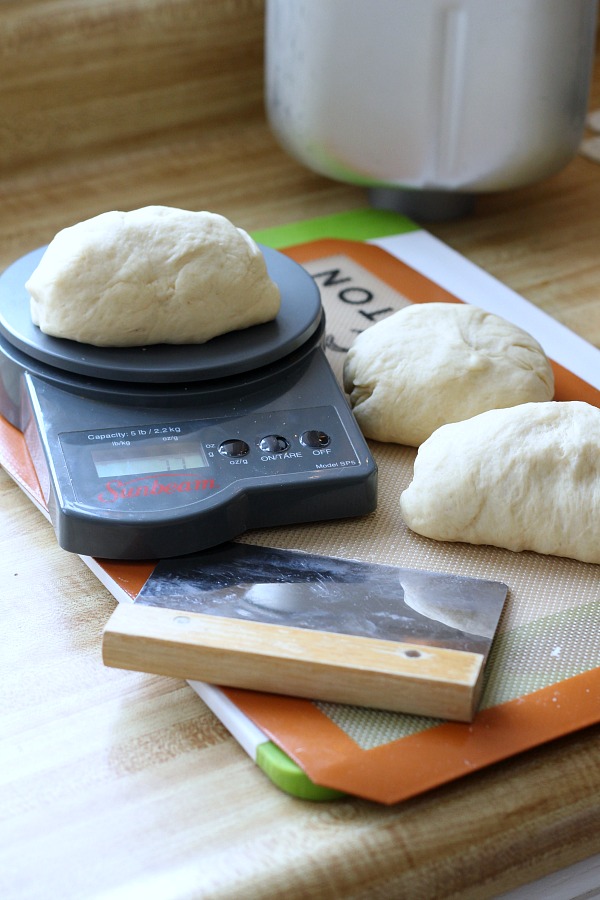 Bake a festive loaf of rich holiday brioche from easy recipe using a bread machine. Frosted with a white glaze and colorful sprinkles. Great food gift idea.