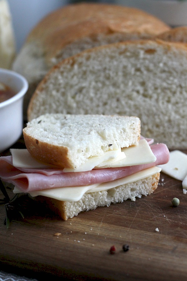 Cracked Pepper, Parmesan and Herbed Bread is full of flavor, slices beautifully and great for sandwiches or buttered and served with soup or salad. Easy recipe dough is made in a bread maker and shaped as desired. Allow to rise, bake and enjoy!