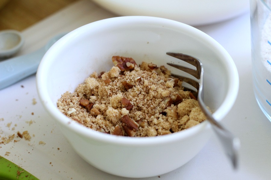 Easy recipe for frosted applesauce bread full of warm flavors of cinnamon, allspice & nutmeg. You don't even need a mixer to make this delicious quick bread.