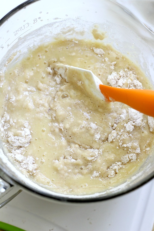 Easy recipe for frosted applesauce bread full of warm flavors of cinnamon, allspice & nutmeg. You don't even need a mixer to make this delicious quick bread.