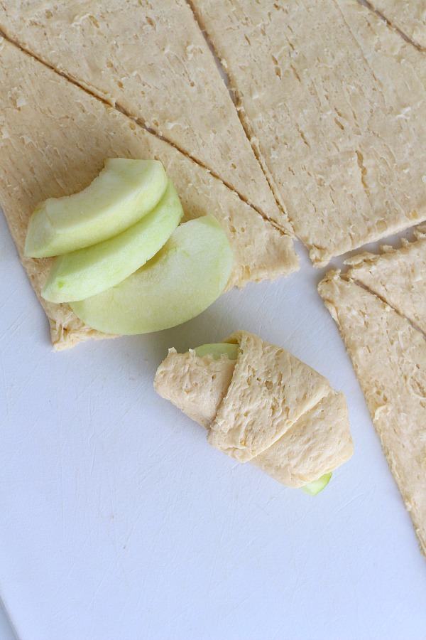 Super easy recipe for autumns favorite fruit, Apple Bundles are made with crescent rolls, cinnamon with a hint of orange. They smell heavenly and are perfect warm from the oven with a scoop of ice cream.