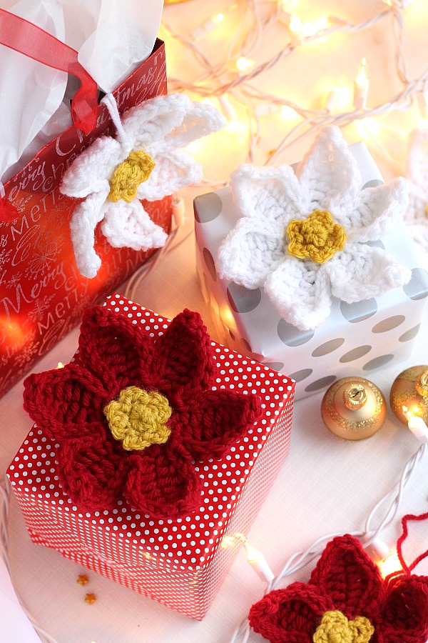 Decorate gifts, wreaths, sew to hats, pillows, or hang as ornaments pretty crochet poinsettia flowers. Festive for holiday decorating and quick and easy to make. 