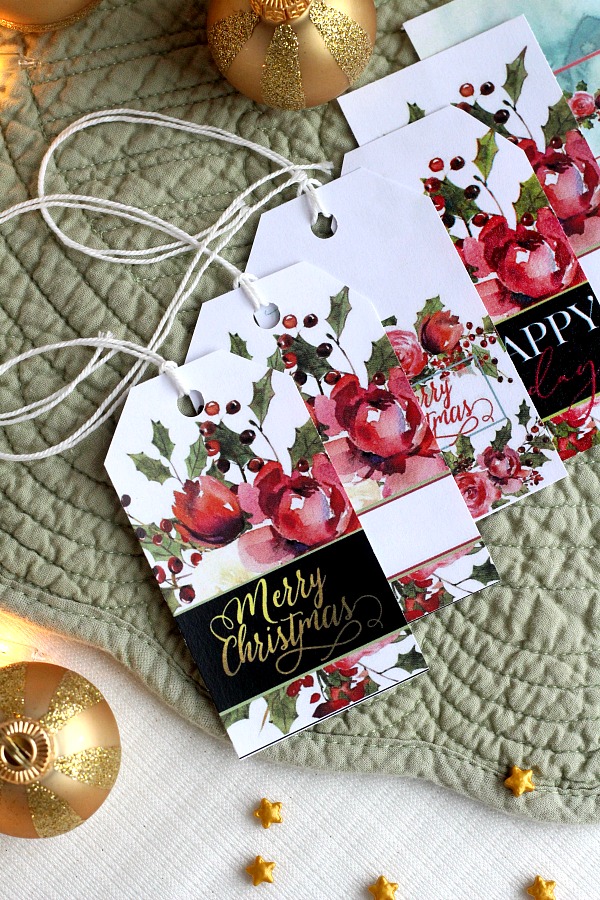 Pretty Holiday gift tags make presents look so festive. Christmas roses and holly have room to write recipient and givers name. Get your printable freebie.