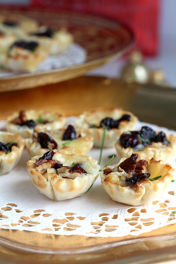 The holidays are a special time of entertaining and parties. Even a small get together with just a few friends is reason enough to set out some tasty tidbits. Brie tartlets with cranberries and cherries is a tasty appetizer that easy, quick and yummy!