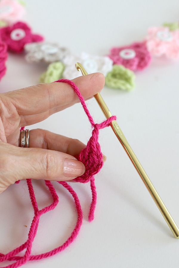 Quick, easy and perfectly pretty, this sweet crochet flower heart is cheerful, bright and a great craft for Valentine's Day. Easy pattern with step-by-step photos for heart, leaves and wreath construction.