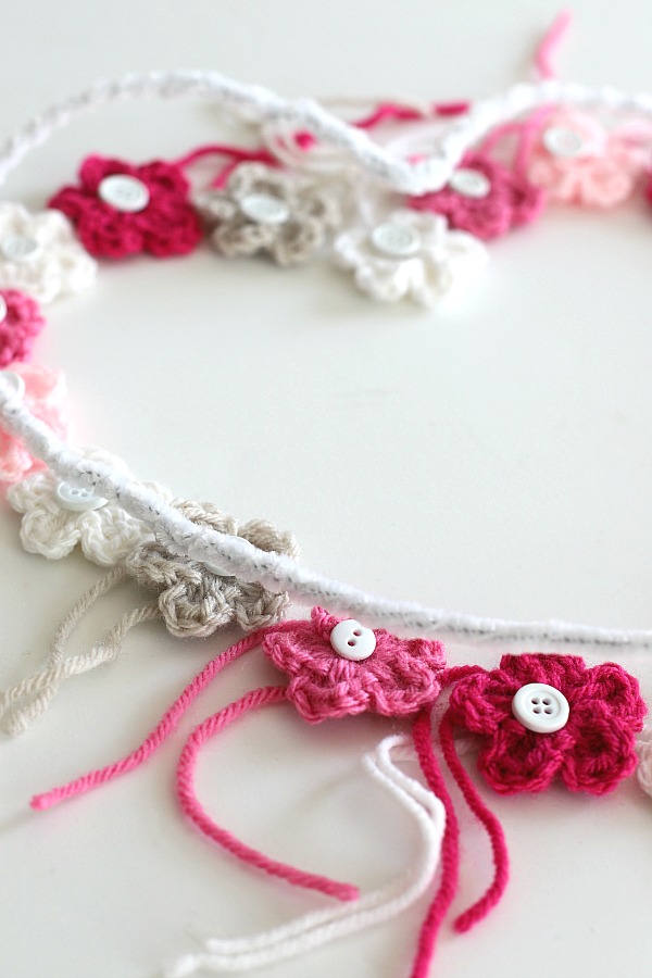 Quick, easy and perfectly pretty, this sweet crochet flower heart is cheerful, bright and a great craft for Valentine's Day. Easy pattern with step-by-step photos for heart, leaves and wreath construction.