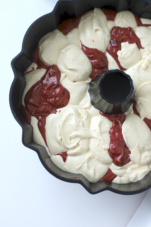 From scratch recipe for a moist red velvet marbled cake made in a Bundt pan has a lovely icing just right for Valentine's Day or celebrating a birthday.